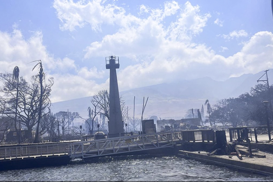The Lahaina Lighthouse, the oldest Pacific Ocean lighthouse, stands among charred trees and a damaged pier. (File photo) 