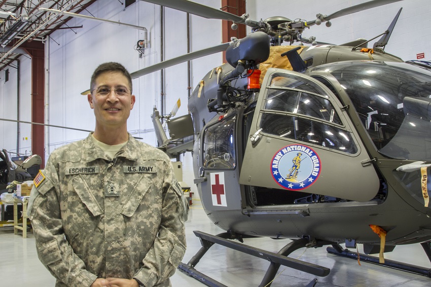 Mark Escherich in uniform with medevac helicopter.