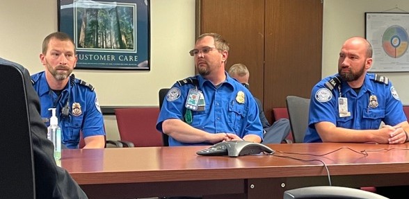 TSO Angelo Demaio, TSO Eric Ferrone, NDO STSO Calvin Arndt recount the events of their double medical emergency. (Photo courtesy of TSA DEN)