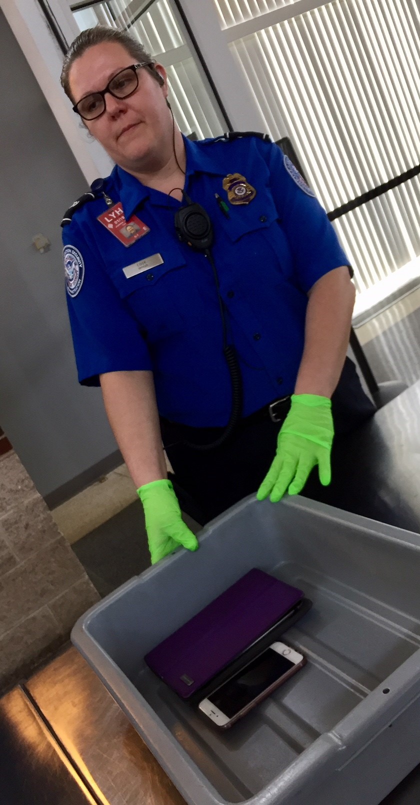 Travelers need to remove electronic items larger than a cell phone from their carry-on bags to place them in a bin at the checkpoint. Cell phones also need to be removed from pockets to be placed either inside a carry-on bag or in a bin. (TSA photo)