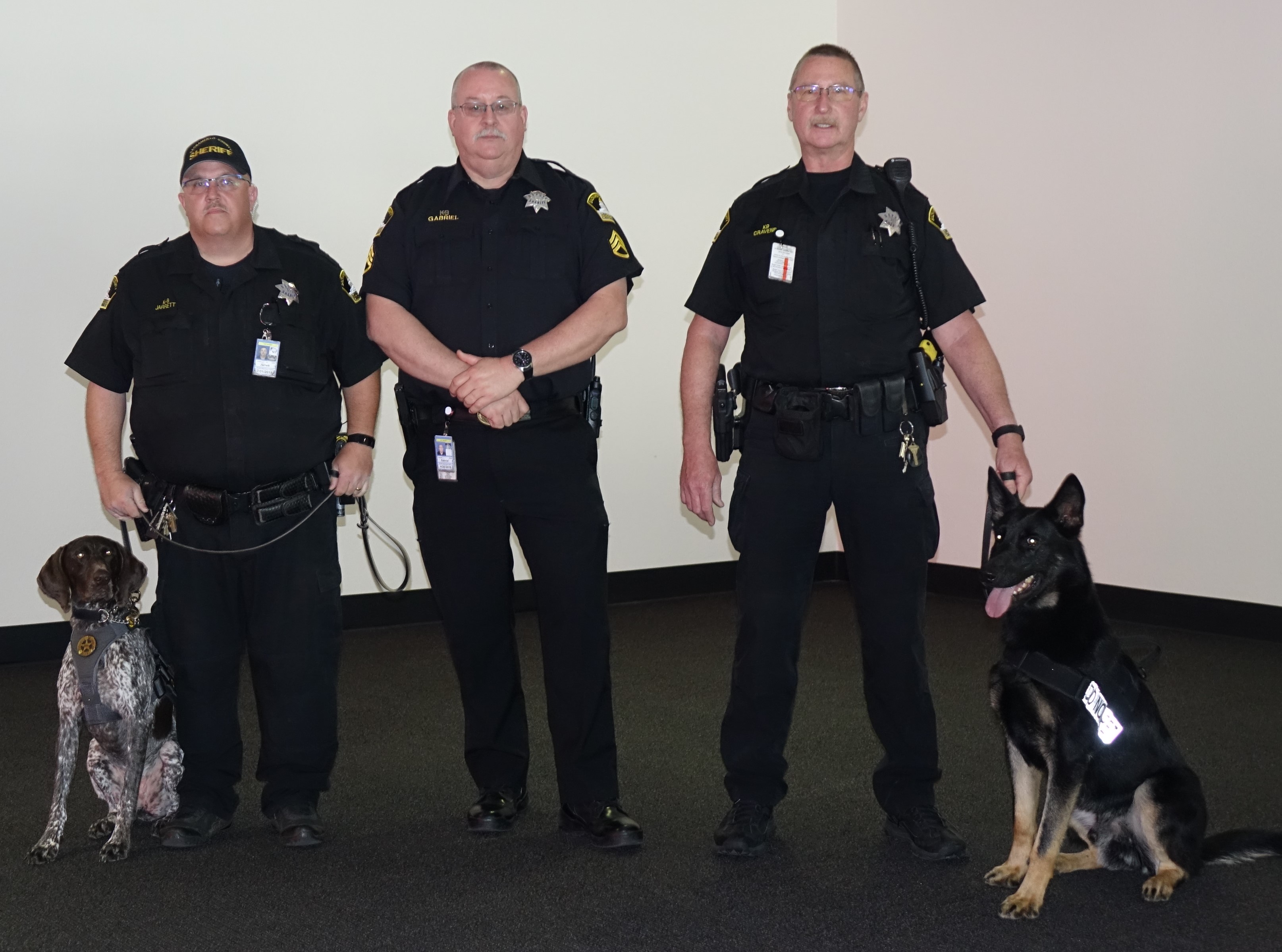 TSA canines Bella-Bell (left) and Quattro-Quappe (right) pose with their handlers from the Sacramento County Sheriff’s Department.