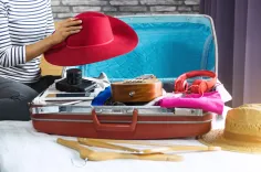 Summer travel items in open suitcase