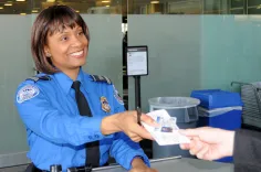 TSA officer checking passenger's ID.