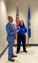 Jacksonville International Airport Training Specialist Restituto Landon explains the significance of TSA Badge 76016 as TSA Officer Jessica Landon looks on.  (Photo courtesy of TSA GSP)