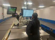 Security Officer reviews checked bag