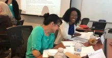 Crystal Daniel (right) and a course participant enjoy a light moment during Leadership Admist Change 2019 continuous learning class.