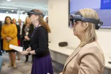 EAA Julie Scanlon and DEAA Kimberly Hutchinson walk through a training scenario with the Microsoft HoloLens mixed reality headset. (Photo by Bruce Milton)