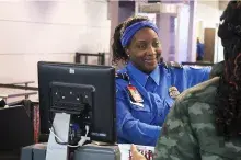 DTW TSO Keyona Espree assists a passenger at the TDC position.  (Photo courtesy of Team DTW)