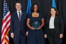 TSA Administrator Pekoske and Senior Official Performing the Duties of the Deputy Administrator Stacey Fitzmaurice recognize Investigations Management Assistant Roxane Jett for earning the Public Service Award during the 2022 TSA Honorary Awards Ceremony. (Photo by Bruce Milton)