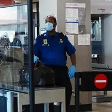 Des Moines International Airport TSA Officer Jerrell Whitaker checks a bag at the inspection table. (Photo by Jason Channon)""