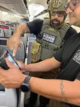 Miami-Dade Bomb Squad officers review X-ray images of a suspicious bag during a training exercise. (Photo courtesy of TSA MIA)