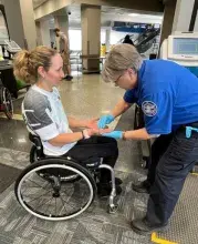 Huntsville International Airport (HSV) Lead TSA Officer Theresa Musso screens a passenger who competed in the Para-Cycling World Cup. (Photo courtesy of TSA HSV)