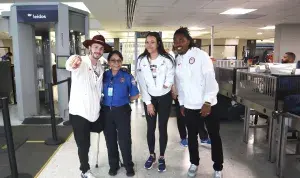 Lead TSA Officer Ana Miranda-Fernandez enjoys a quick chat and photo with three U.S. Olympians who flew out of Washington Dulles International Airport. (Photo by Sena Park)
