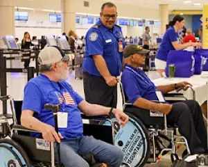 Luis Muñoz Marín International Airport Officer help wheel veteran heroes to special screening before their flight. (Photo courtesy of Carlos Z. Cardona)