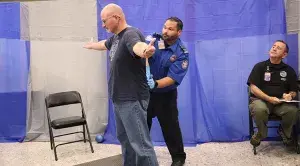 Indianapolis International Airport Expert Security Training Instructor Chris Mercado from Team Indiana pats down a volunteer during the 2023 TSA National Olympics checkpoint competition. (Photo by Kyle Martin)