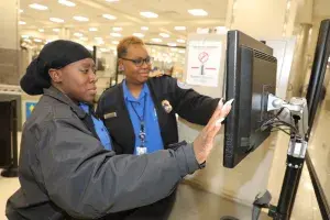 Hartsfield-Jackson Atlanta International Airport Lead TSA Officer Theodosia White (left) and Supervisory TSA Officer Brenda Nelson confer over an X-ray image. (Photo by Thomas Harris)