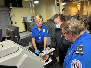 Traverse City Master Security Training Instructor Nancy Farkas teaches TSA Lead Officer Lindsay Peaslee and Master Security Training Instructor Tim Elmer about new checked baggage equipment. (Photo courtesy of TSA Cherry Capital Airport)