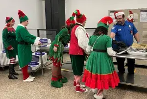 Seattle-Tacoma International Airport TSA Officer Damacio Lopez screens some of Santa’s elves. (Photo by BrookHunter Whelchel)