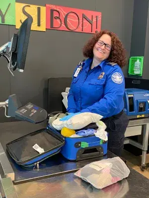 Northwest Arkansas National Airport Expert Security Training Instructor Cherry Hooten checks a carry-on bag.  (Photo courtesy of TSA XNA)