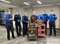 From left, STI Matt Peebles, LTSO Brandi Jenkins, TSO John Schroeck, TSM Mike Ellis, LTSO Paul Perrigo and TSO Tim Smith stand with the robotics’ team 3D printer and robot to show the airports’ Officers what is possible and can be done with 3D printing. (Photo provided by Mike Ellis)