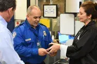 Federal Security Director Jenel Chang presented TSA Officer Roberto Gonzalez a TSA-MIA coin for his heroic actions. (Photo courtesy of Steven Marquez and Alvaro Galan)