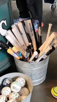 Bucket of souvenir bats for sale at the MLB 2023 All-Star Game in Seattle. All bats must travel in checked luggage.