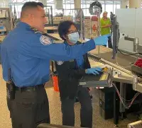 Charleston International Airport Lead TSA Officer William Piette assists Officer Celeste Raynes on X-ray. (Photo by Jonathan McCandless)
