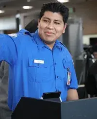 DTW TSA Officer Dominic Cherenzia greets passengers with a smile at the TSA checkpoint. (Photo by Robert Gilmore)