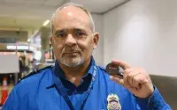 Roberto Gonzalez holds the TSA-MIA coin he was presented for saving a life. (Photo courtesy of Steven Marquez and Alvaro Galan)