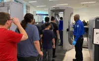Under Officer Earl Battice’s guidance, some young adults with special needs take a trip through the TSA checkpoint during a special LAX tour. (Photo by Lorie Dankers)