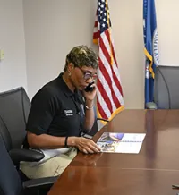TSA Academy East Supervisory Training Instructor Dicy Peppers on a phone call to discuss training operations. (Photo by Jackie Ray Harvey)