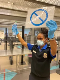 A TSA officer reminds travelers not to bring their beverages into the security checkpoint. (TSA photo)