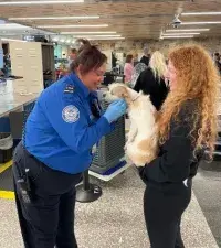 Will Rogers World Airport Lead Officer Leah Park screens a passenger and her pet. (Photo courtesy of TSA OKC)