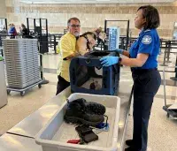 It is important to remember to remove your pet from its carrier at a security checkpoint. Never send a pet through the X-ray unit. (TSA photo)