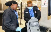 Hartsfield-Jackson Atlanta International Airport Lead TSA Theodosia White (left) and Supervisory TSA Officer Brenda Nelson conduct a bag search. (Photo by Thomas Harris)