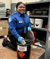 Denver TSA Officer Chelsea Scott properly disposes hazardous material as part of her role as DEN’s primary collateral duty safety officer. (Photo by Carie Muirhead)