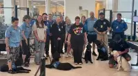 RSW Canine Supervisor Wyatt Rhoden (standing second from right) and team members from Southeastern Guide Dogs Inc. (Photo courtesy of Wyatt Rhoden)