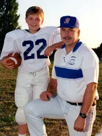 From left, Hillsboro, Oregon, Pop Warner Cowboys full back and offensive lineman Robert Spinden and Coach Jim Spinden. (Photo courtesy of the Spinden Family)