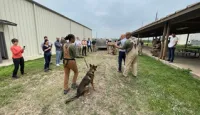 ECAC members watch a Department of Defense (TSA Mission Partner) canine in action. (TSA photo)