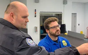 Niagara Falls International Airport TSA Officer Christian Schack and Lead Officer Chris Cook review a checkpoint monitor. (Photo courtesy of Christian Schack)