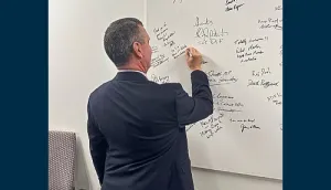 The Administrator adds his name to the DIU Innovation Board. (Photo by Steven Parker)