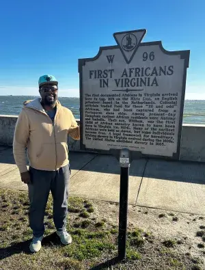 Raymond Alston stands next to a historical marker commemorating the arrival of Africans to Virginia in 1691. (Photo courtesy of Ray Alston)