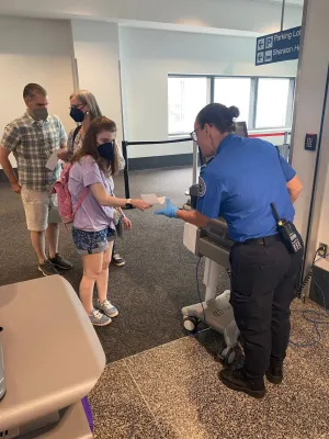 Lead Officer Belinda Hayden helps a girl with autism practice going through security. (Photo courtesy of TSA Connecticut)