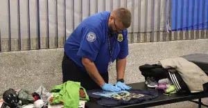 Appleton International Airport TSA Officer Chris Bossart, representing Team Wisconsin, performs a full open bag search during the baggage competition. (Photo by Kyle Martin)