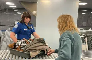 Phoenix Sky Harbor International Airport (PHX) TSA Officer Erica Messina engages with a passenger at a PHX checkpoint. (Photo by Patricia Mancha)