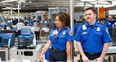 Transportation security officers at Washington Dulles International Airport sport the TSA royal blue uniforms still being used today. (TSA photo)
